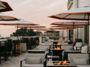 Outdoor terrace with fire pits and ocean-view seating at sunset at the Lobby Bar and Terrace, Terranea Resort in Rancho Palos Verdes.