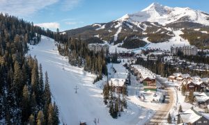 Aerial view of Big Sky Resort with ski-in/ski-out chalets nestled in the snowy mountains.