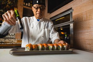 A chef at Bashi making fresh sushi rolls at Terranea Resort at Rancho Palos Verdes, California 