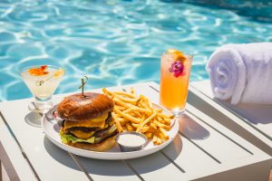 A poolside cheeseburger with fries and cocktail snack at The Grill at the Pool in Terranea Resort at Rancho Palos Verdes, California 