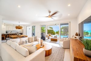luxury modern thompson cove villa living room with open layout private pool lounge chairs and ocean view beach access