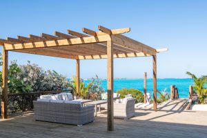 poolside lounge area in little exuma with panoramic view of turquoise blue caribbean waters