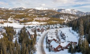 Scenic winter view of Big Sky Resort with ski-in:ski-out lodges and the ski mountain in the background