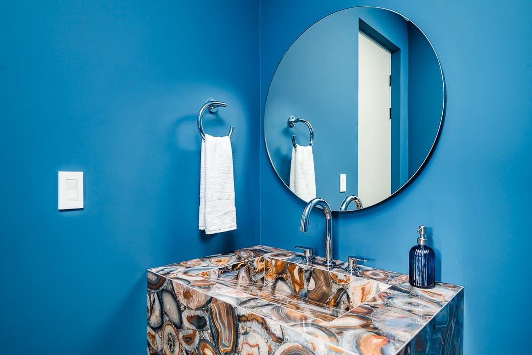 Luxury bathroom in the Reserva Conchal penthouse featuring a stylish blue accent wall, modern fixtures, and elegant design details.