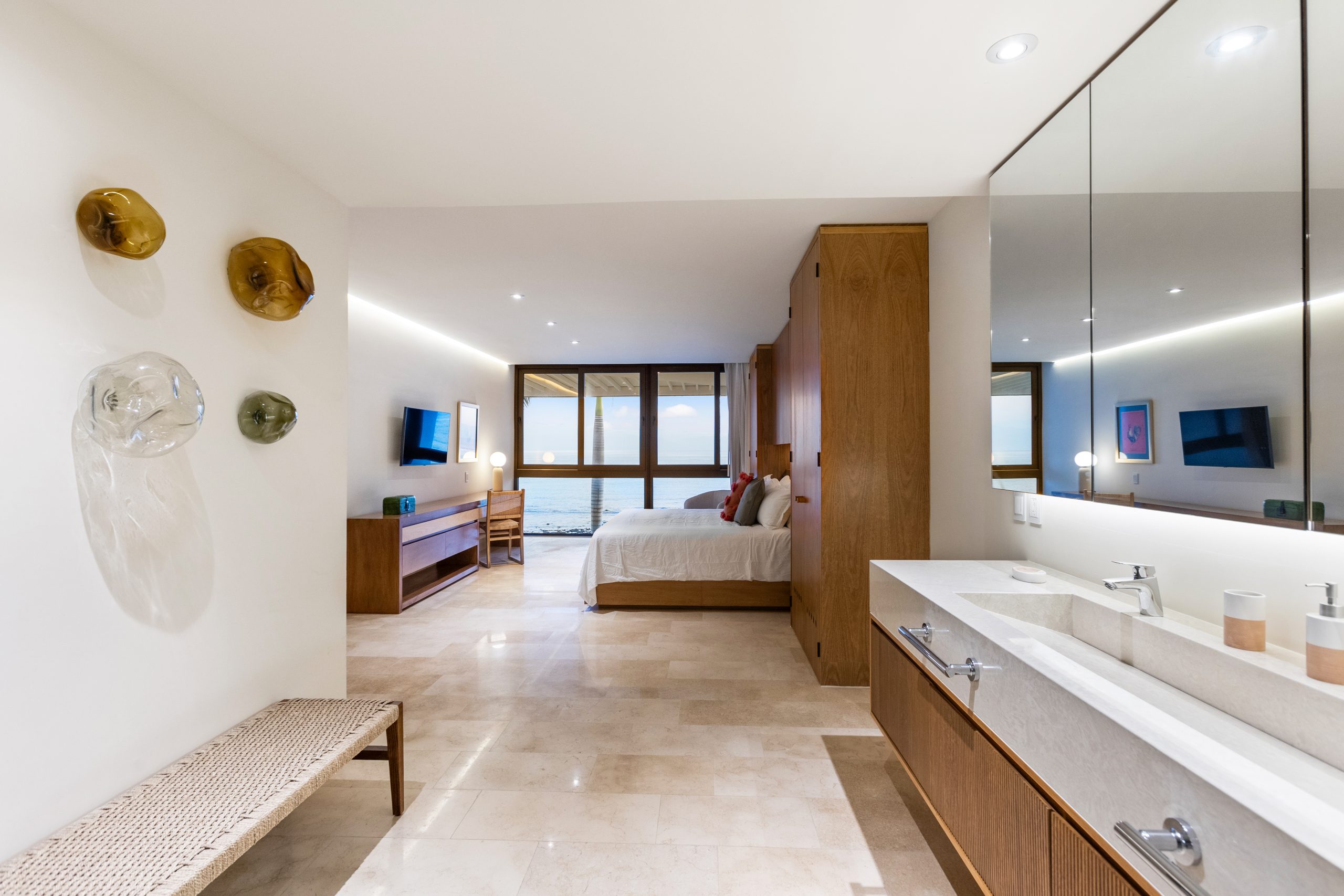 Modern luxury villa in Nuevo Vallarta, Mexico featuring contemporary architecture, private pool, and tropical garden views near the beach.