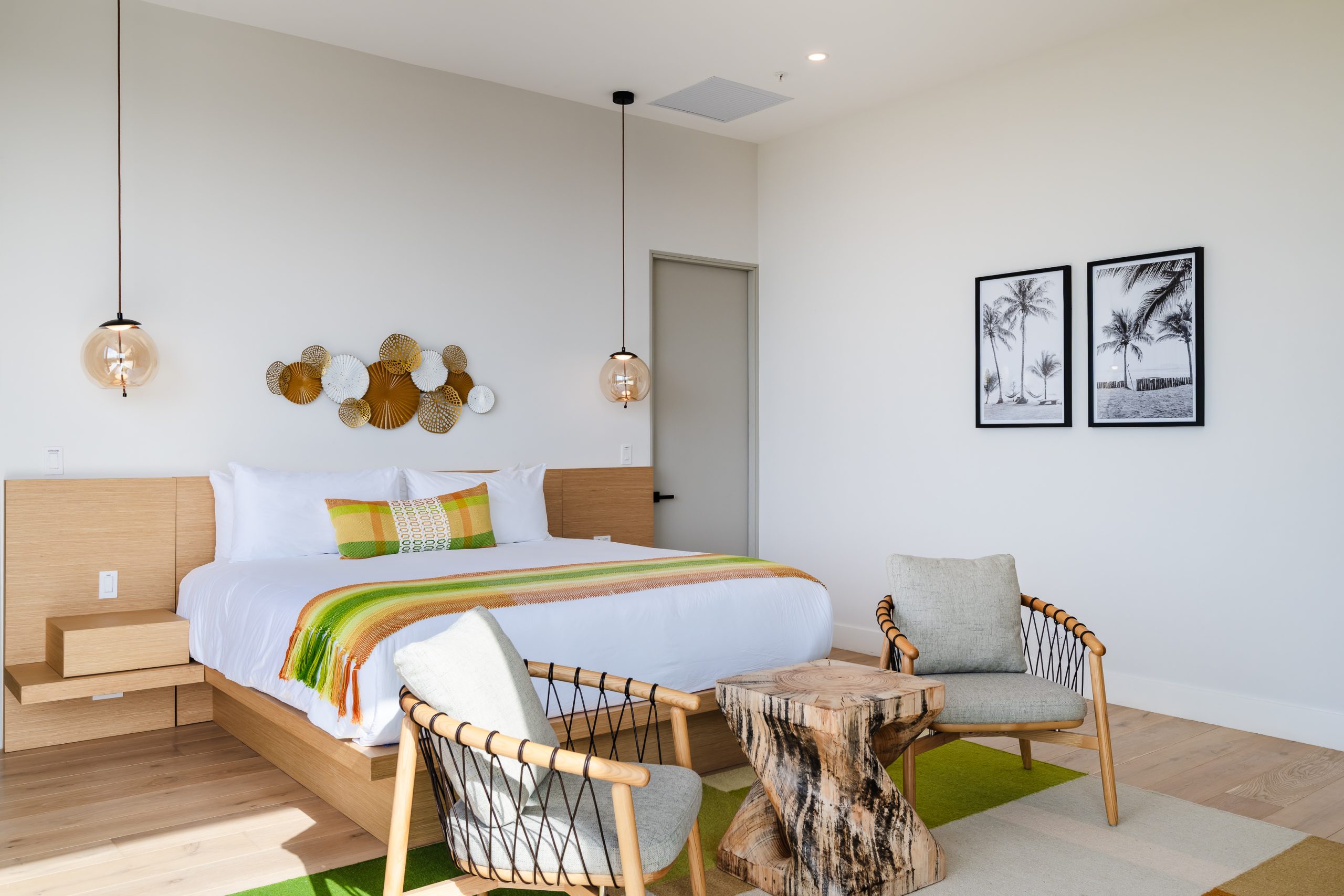 Luxury bedroom with floor-to-ceiling windows overlooking lush greenery and ocean views at the Reserva Conchal penthouse in Costa Rica