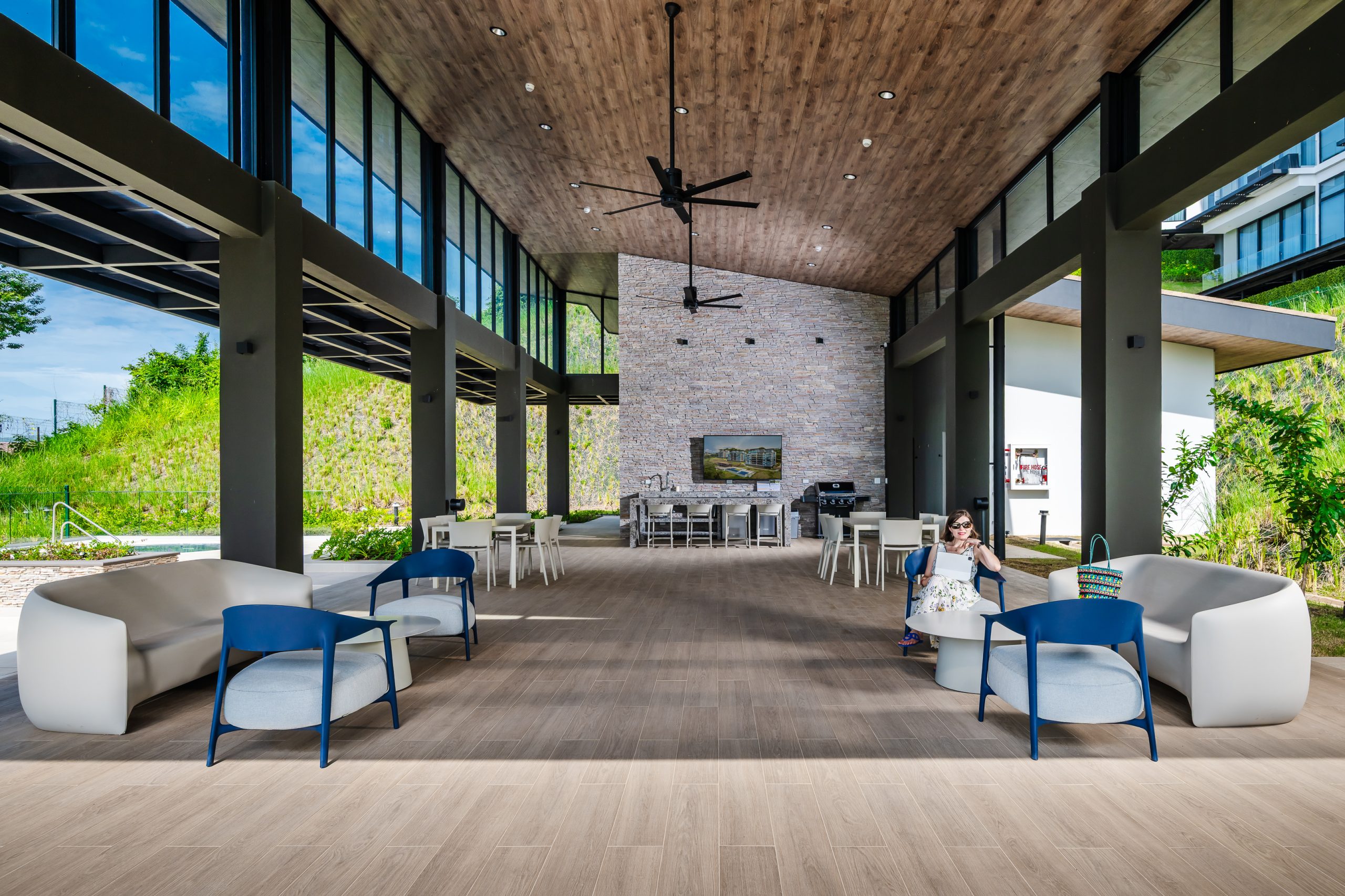 Open-concept Reserva Conchal clubhouse welcoming guests with elegant architecture, spacious lounge areas, and views of the surrounding tropical landscape.