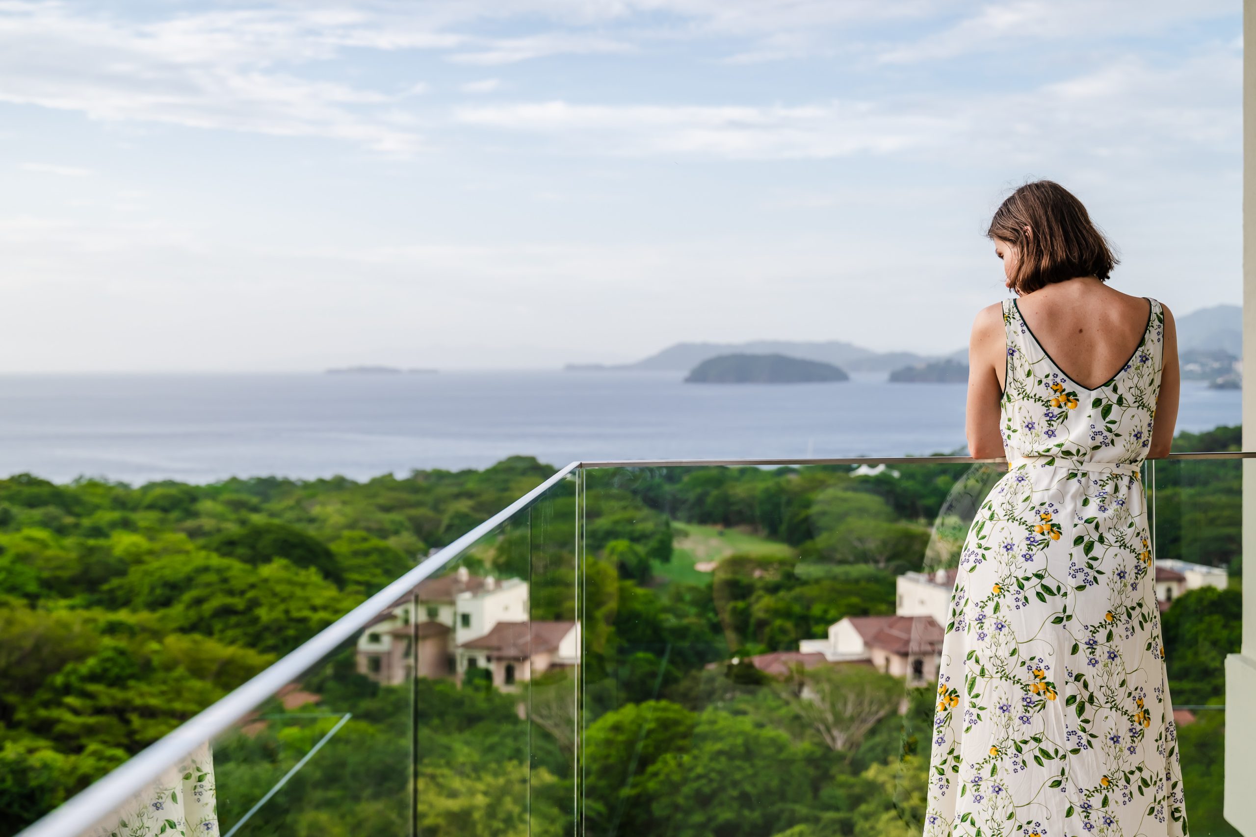 Marina Salley, Head of Investor Relations, relaxing on the terrace of the Reserva Conchal penthouse, enjoying panoramic views of Costa Rica’s coastline and tropical scenery.
