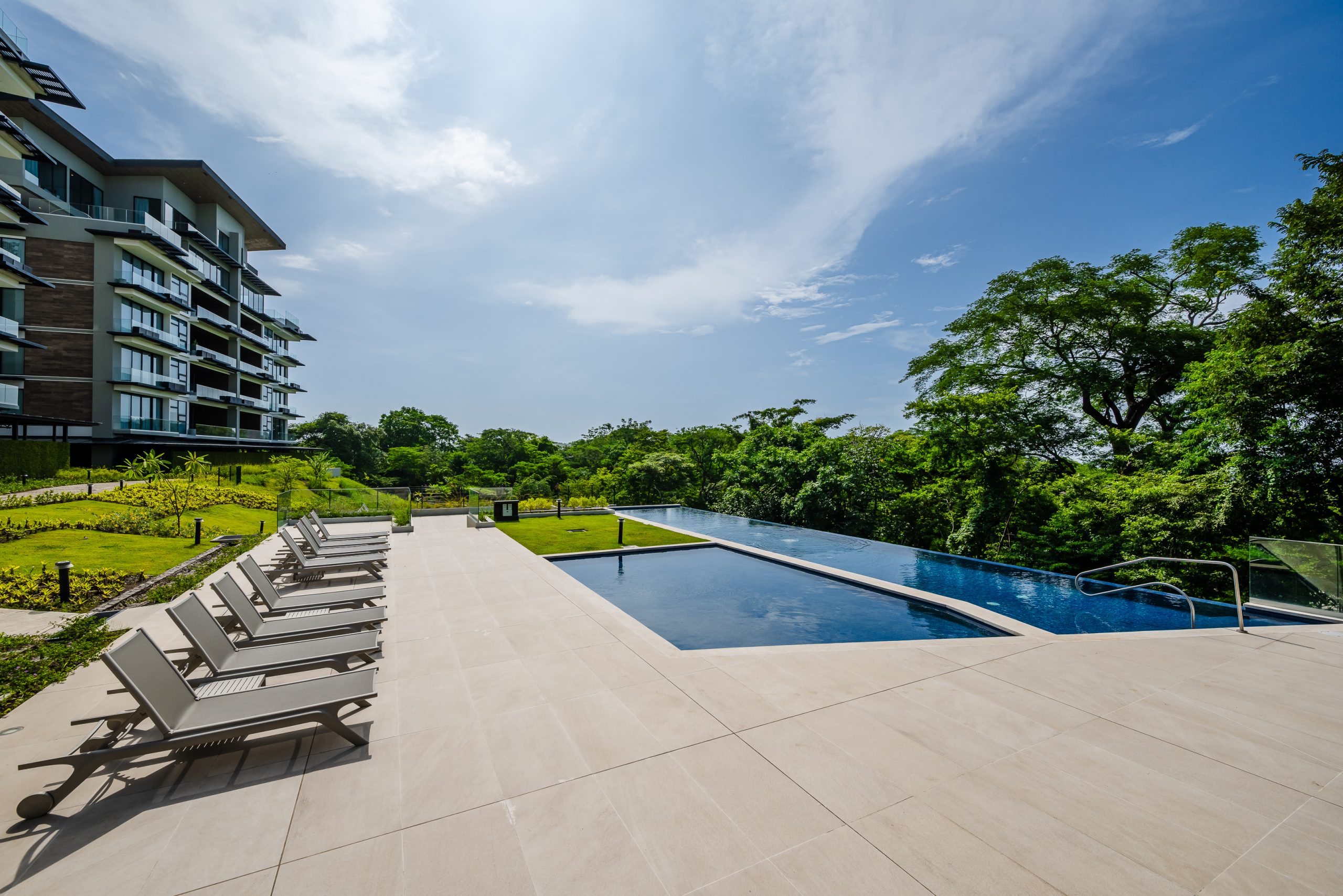 enjoy complimentary access to the luxury pool at the Reserva Conchal Clubhouse, surrounded by lush tropical gardens and offering a serene space to relax and unwind.