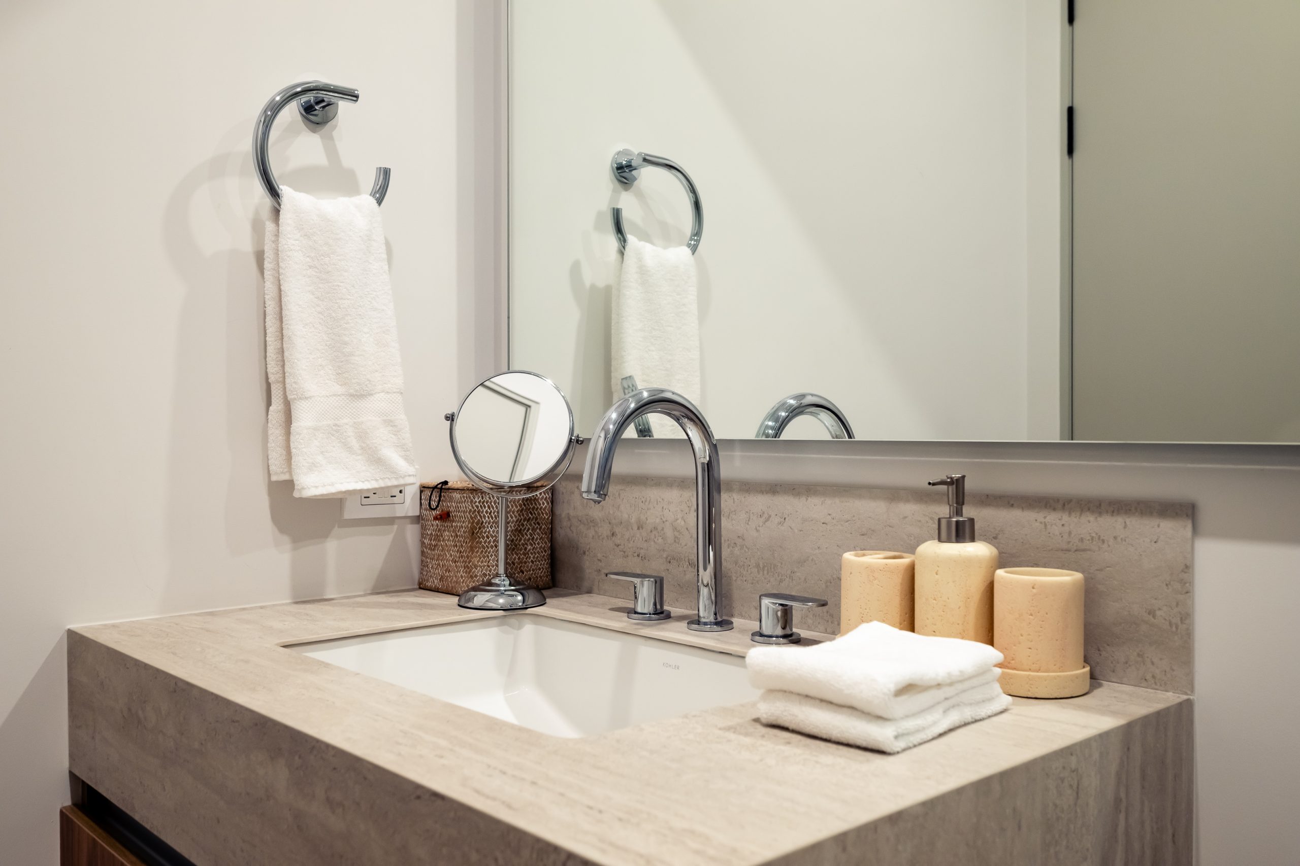 Modern bathroom with a large mirror and luxury sink inside the Reserva Conchal penthouse, featuring elegant finishes and contemporary design.