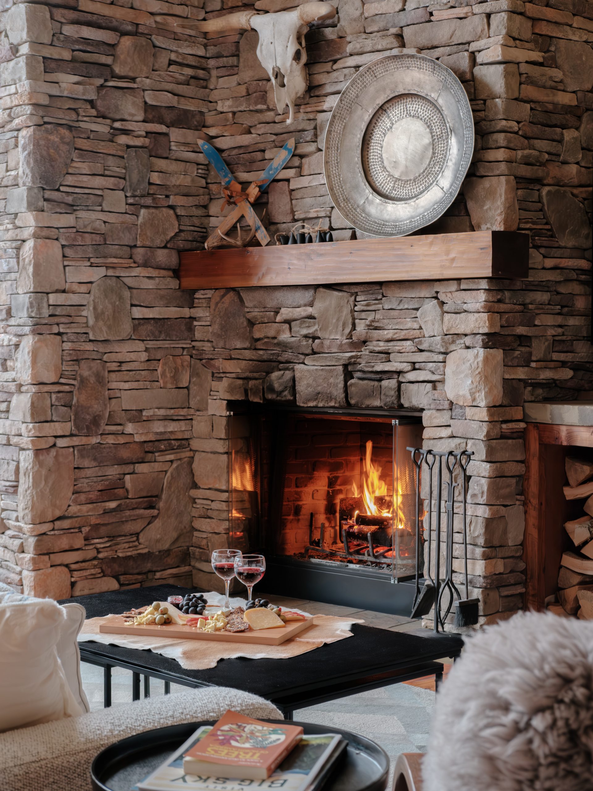 Rustic-modern living room with fireplace in Big Sky Resort.