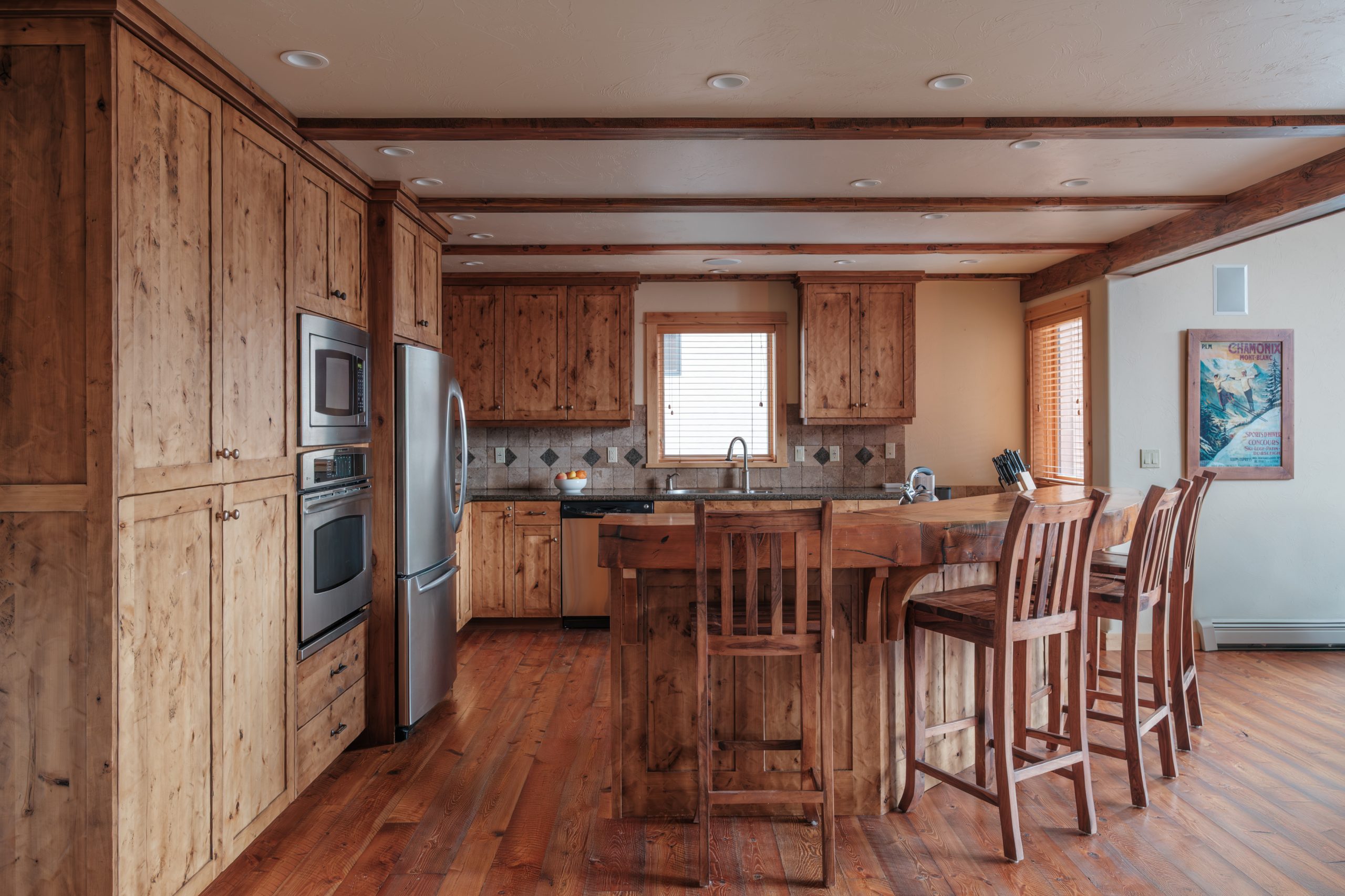 Luxury kitchen in Big Sky Resort home with wooden countertops and large island.