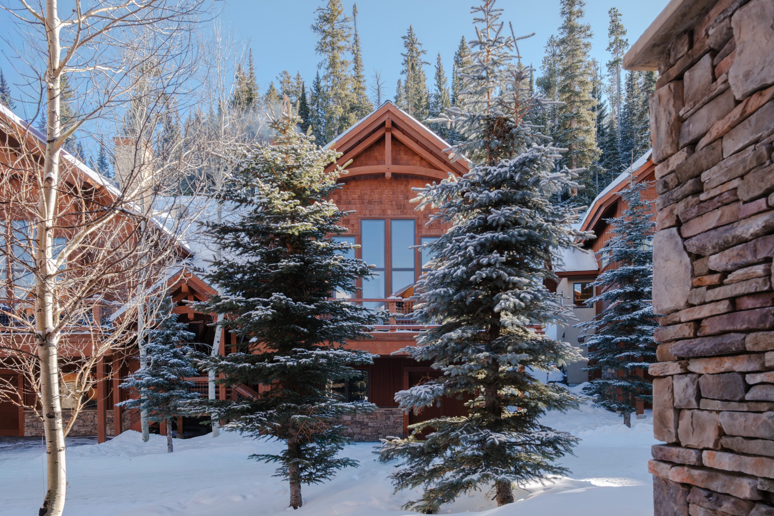 Luxury mountain estate exterior surrounded by snow in Montana.