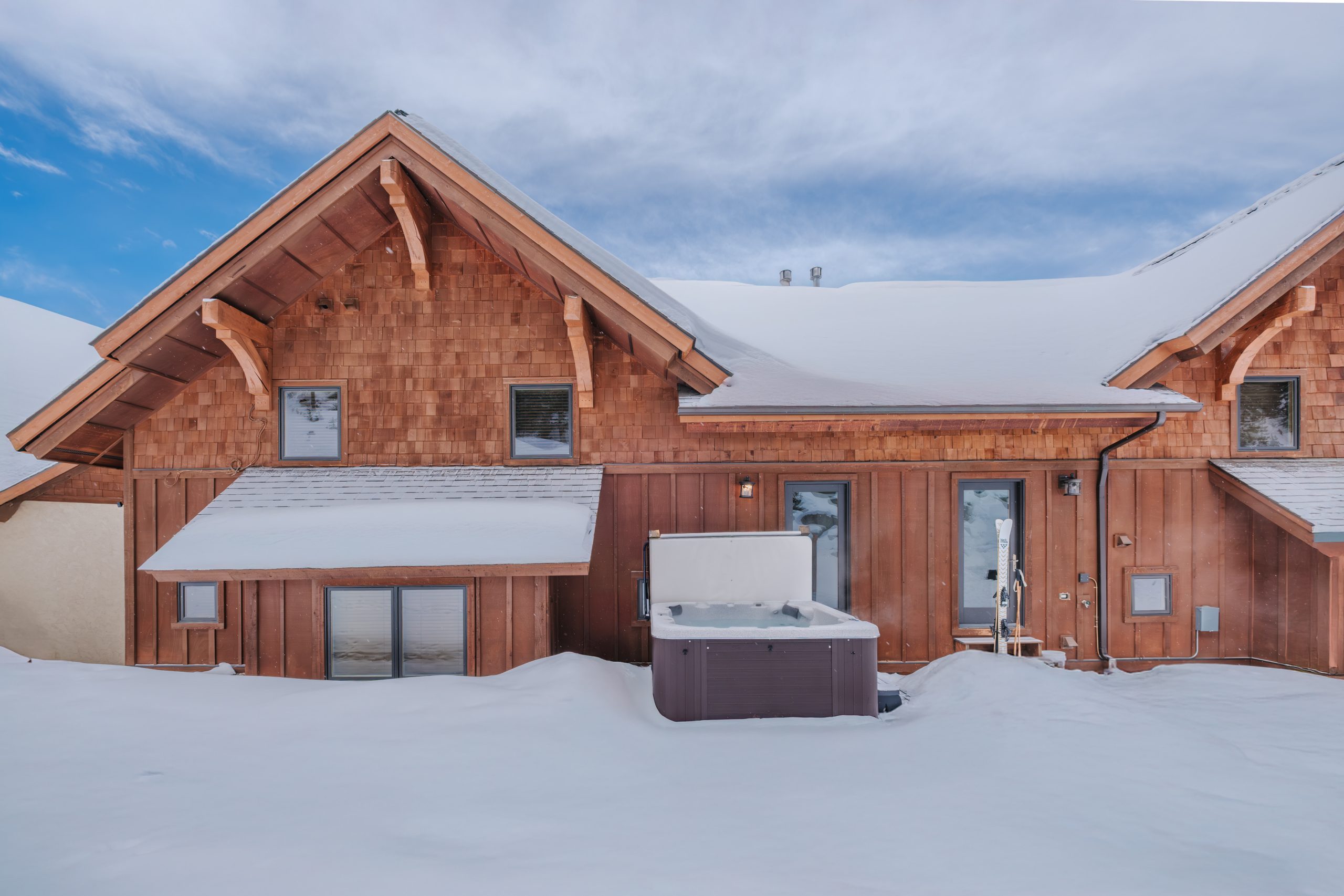 Big Sky Resort mountain retreat with private hot tub and snow-covered peaks.