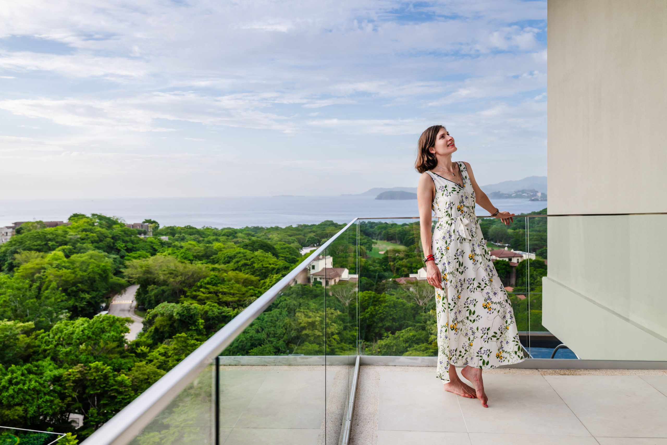 Head of Investor Relations Marina Salley Enjoying the Stunning View of the Pacific Ocean from the Terrace at Solaris Reserva Conchal Penthouse in Costa Rica