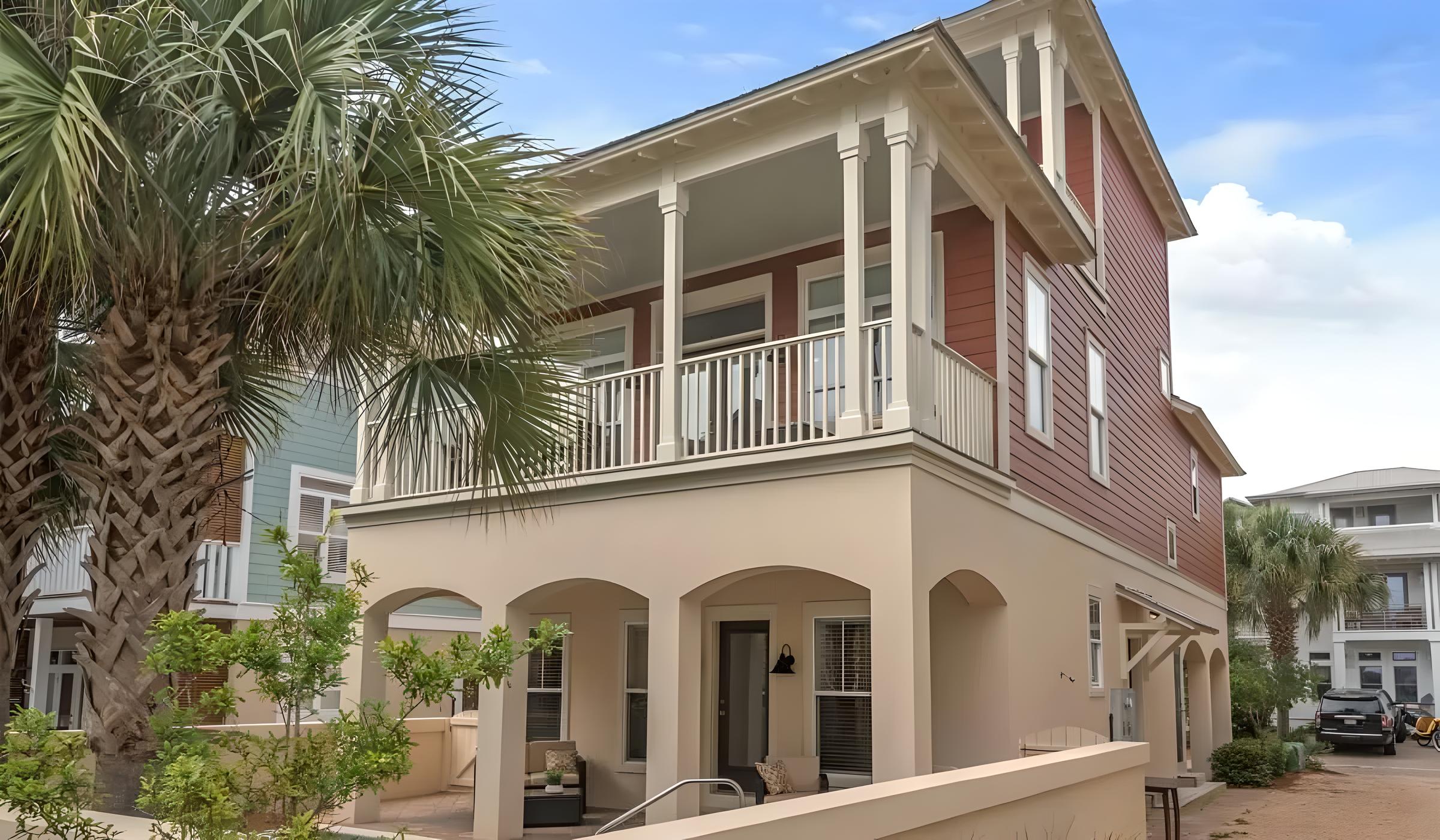 Luxury Seacrest Beach home with modern renovations, featuring palm trees, a spacious balcony, and proximity to the Gulf of Mexico, ideal for family vacations or romantic getaways.