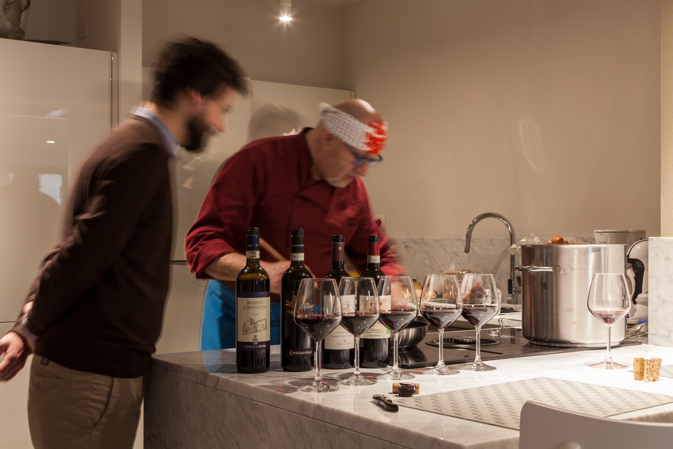 Private chef lining up wine for tasting in a Luxury Penthouse in Siena, Italy