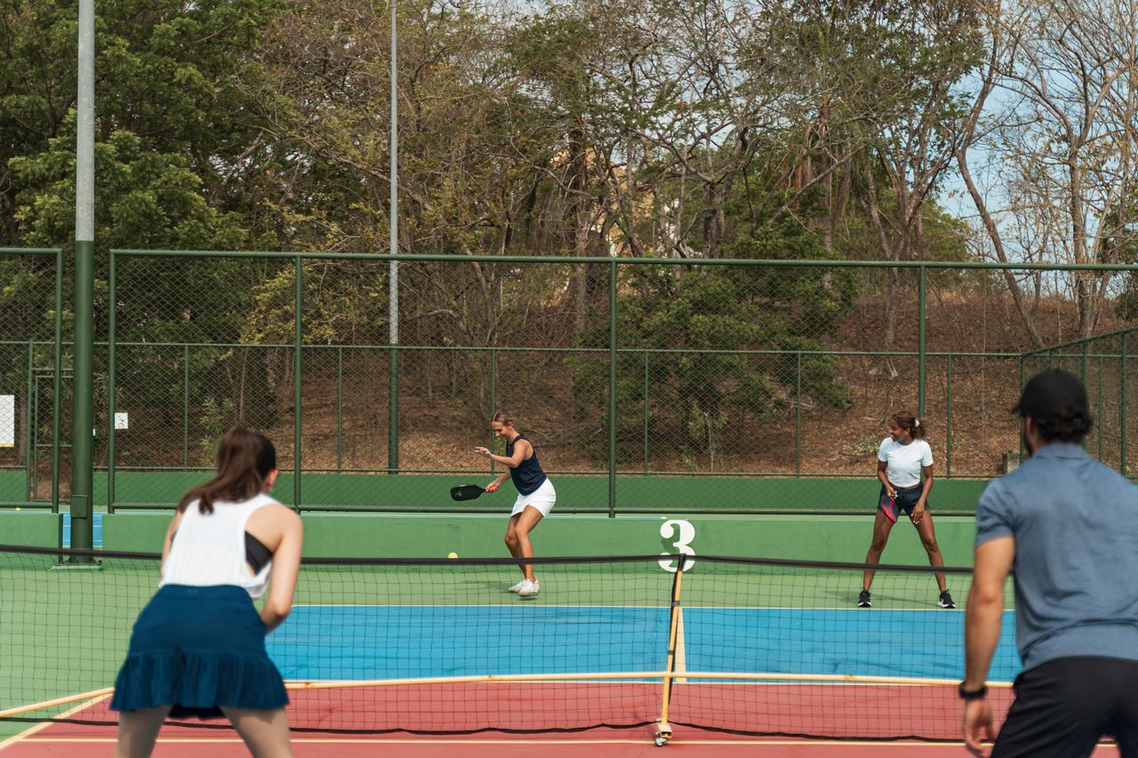 Reserva Conchal - Friends playing Pickleball in a tennis court in reserva conchal