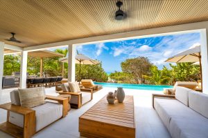 Relaxing patio with private pool and beachfront access where you and your family can make memorable experiences in a luxurious beach house in Thompson Cove, Turks and Caicos by Equity Residences