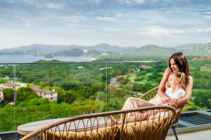 Woman Enjoying the Views of the Ocean with her Daughter from the Solaris Reserva Conchal Penthouse in Cost Rica
