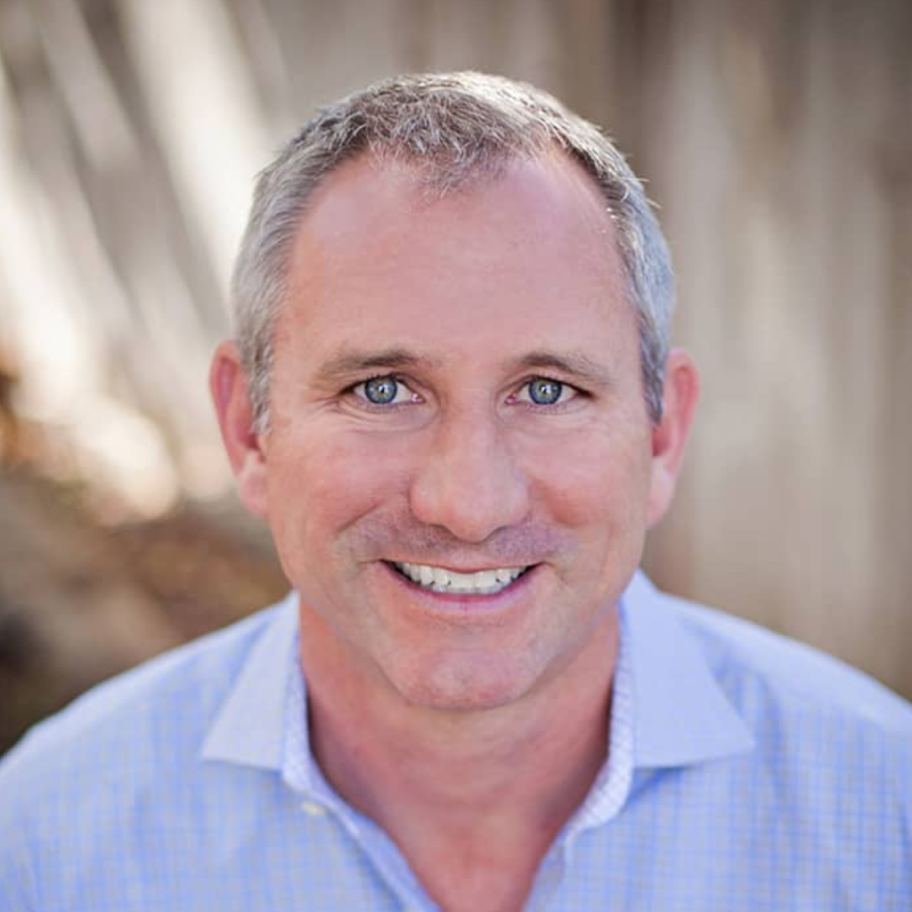 John Long in a light blue shirt, representing the Equity Residences team, emphasizing expertise in luxury vacation home investments.