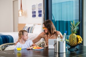 Woman and Daughter Eating at the Outdoor Dining Area at Reserva Conchal Penthouse
