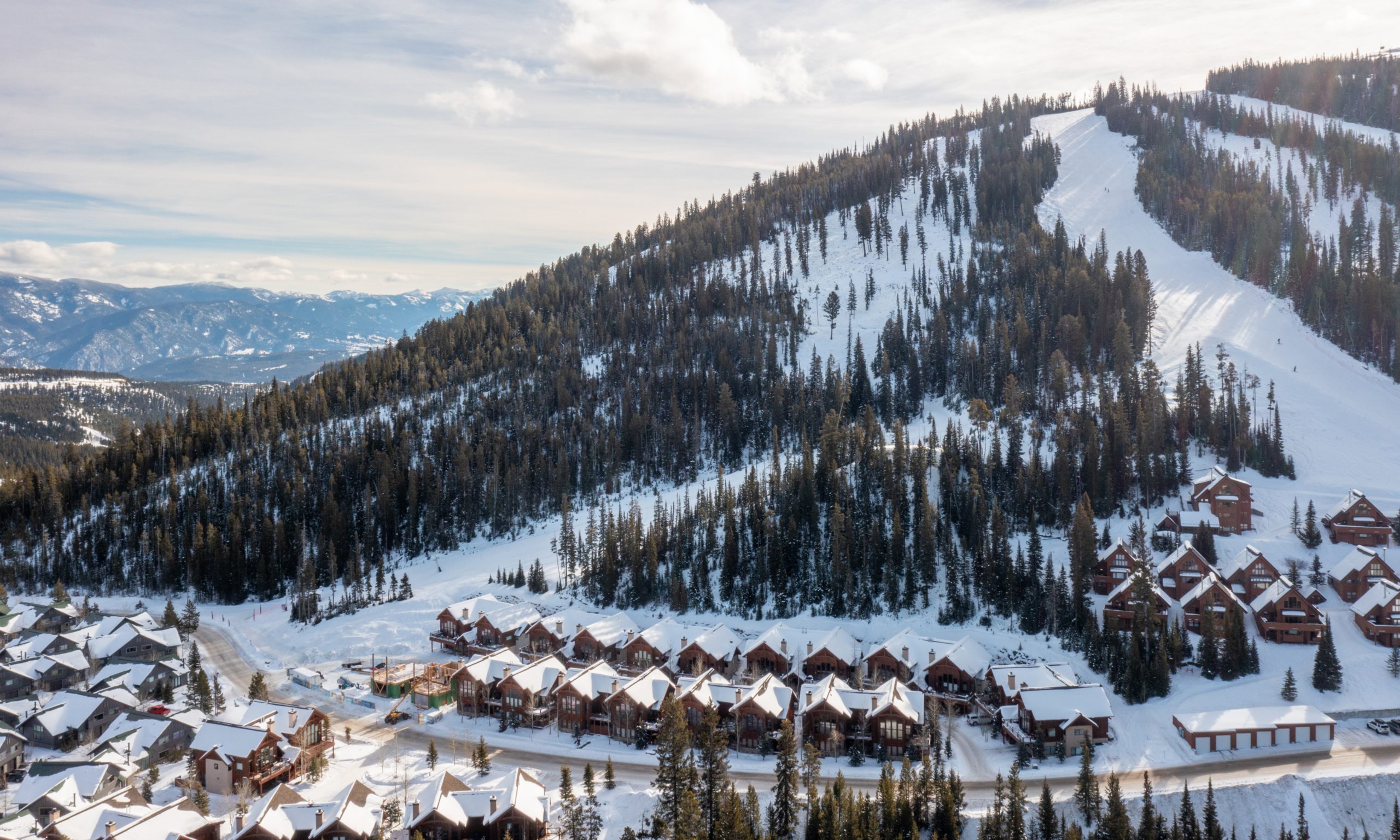 Big Sky Resort mountain view with ski slopes and luxury homes in Montana