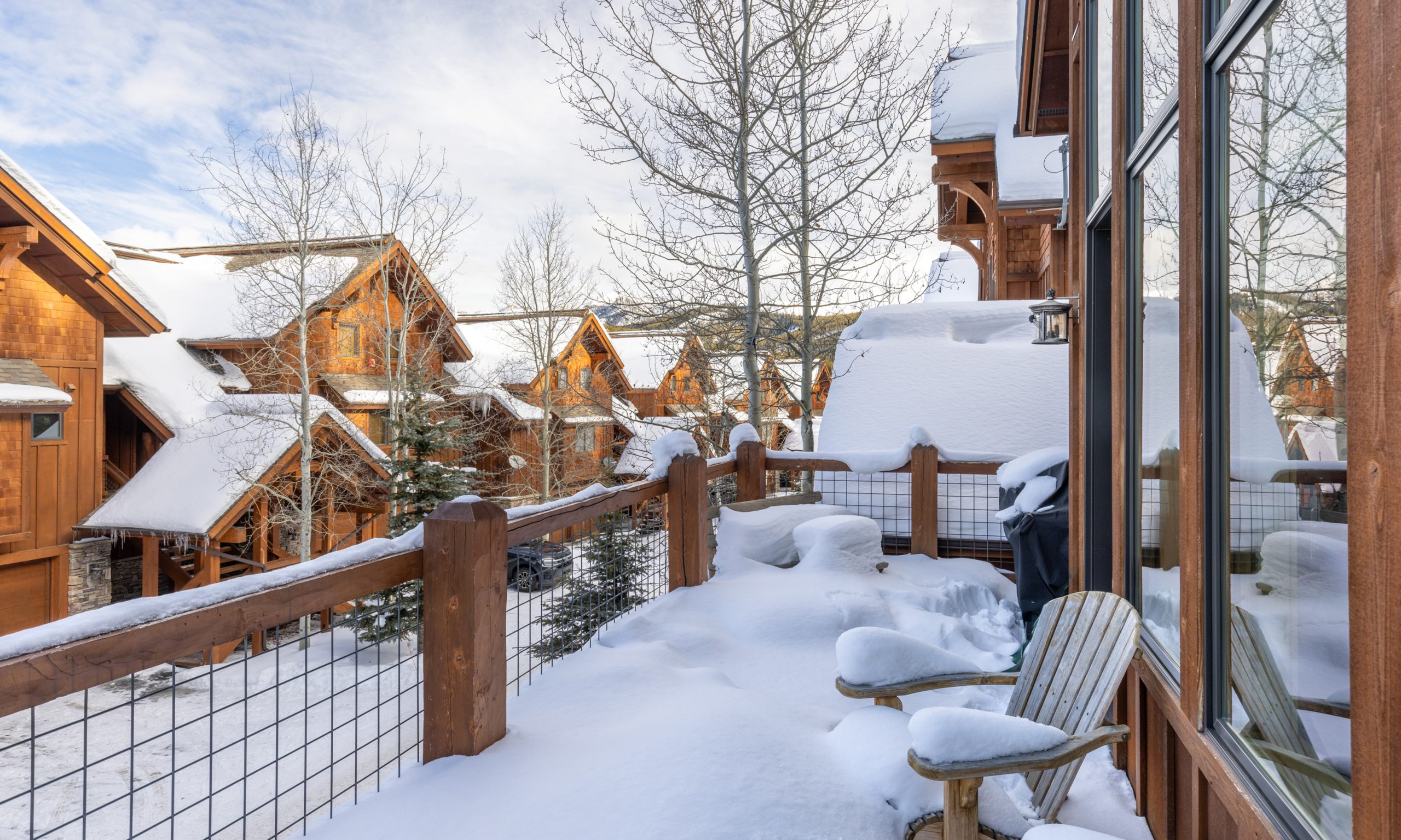 Elegant snow-covered mountain home at Big Sky Resort, steps away from ski slopes in Montana