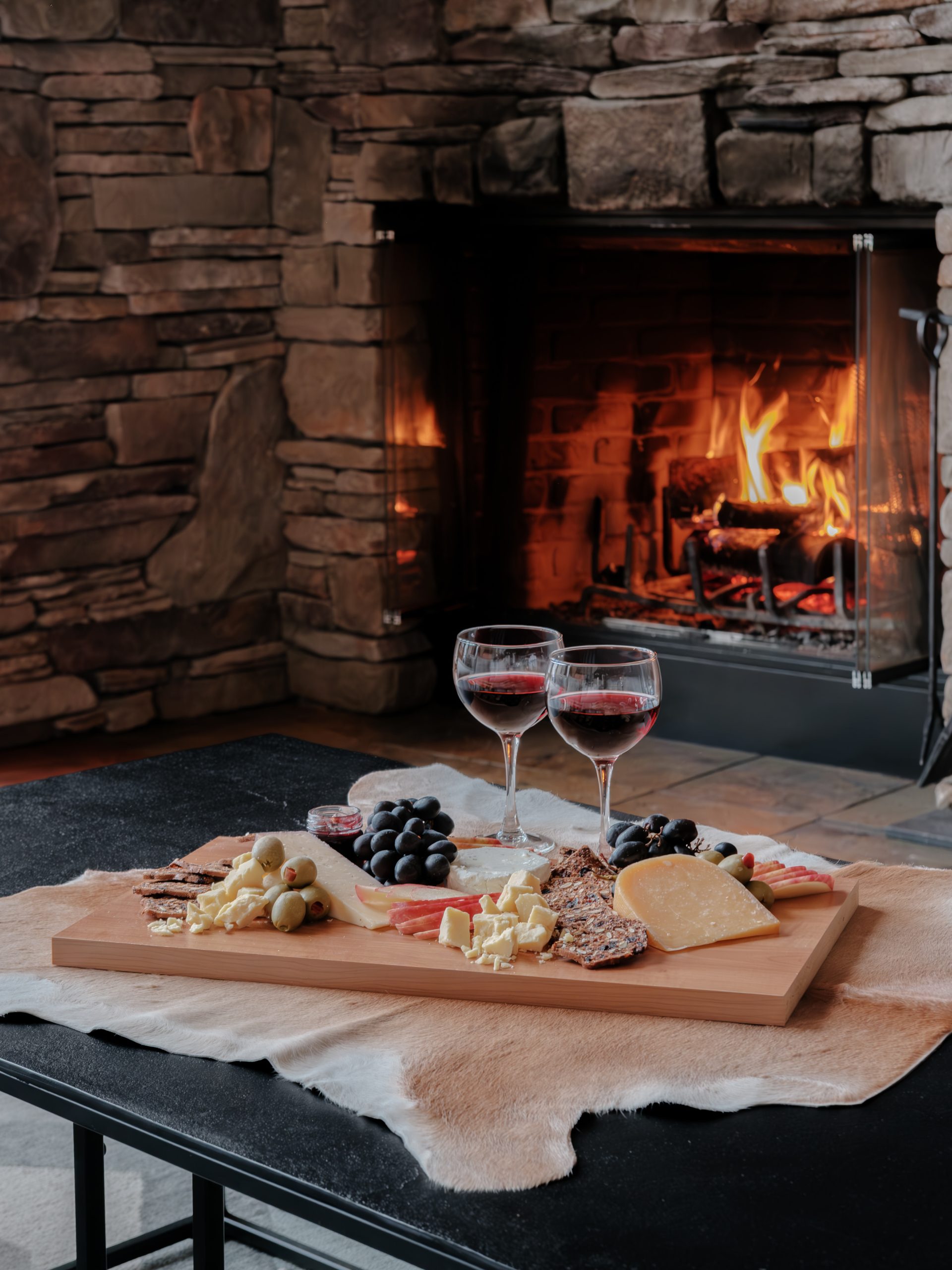 Spacious living room with vaulted ceilings and panoramic mountain views in Big Sky luxury home.