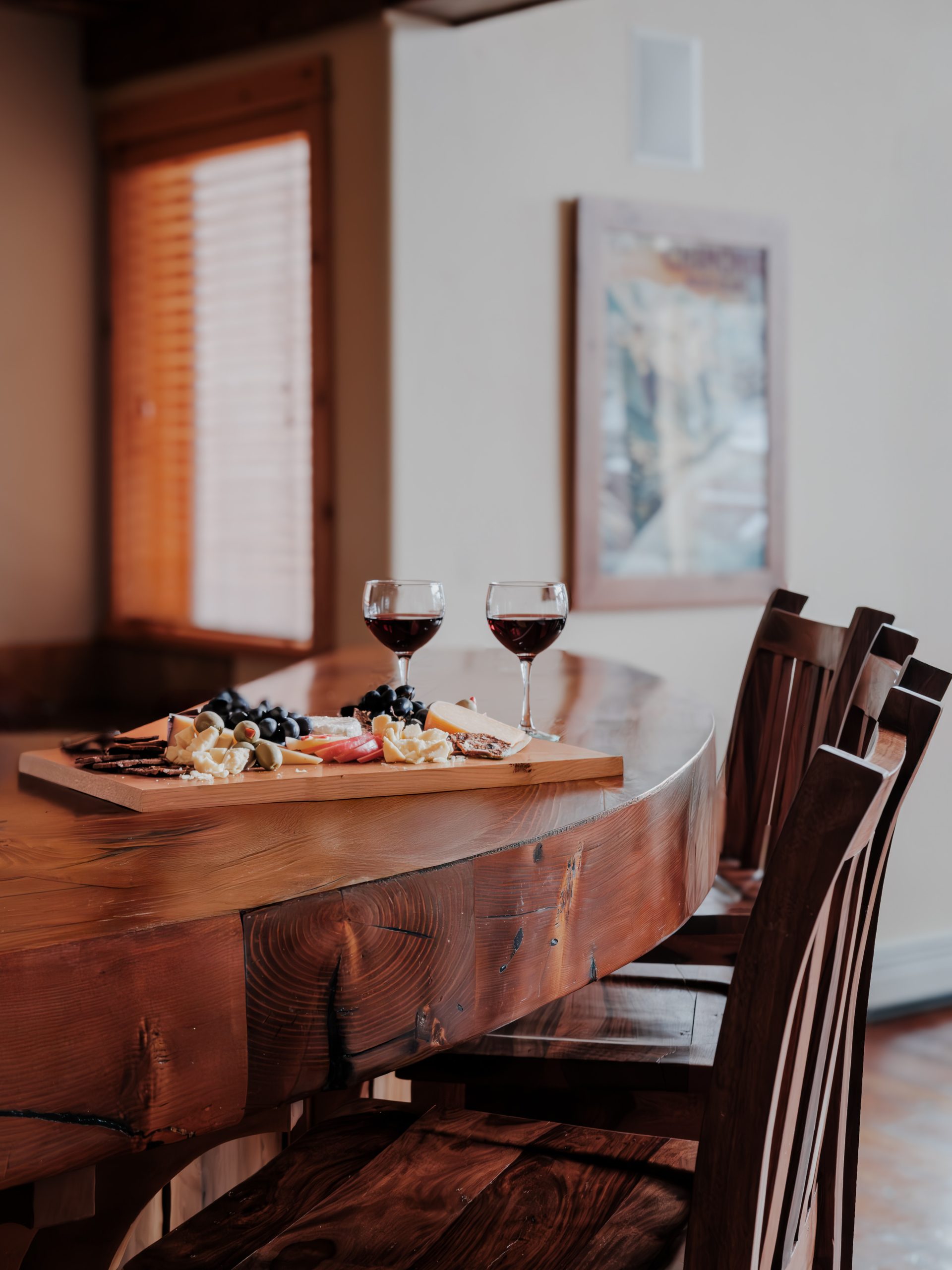 Beautiful rustic dining table in Big Sky mountain vacation home with wine glasses and charcuterie board