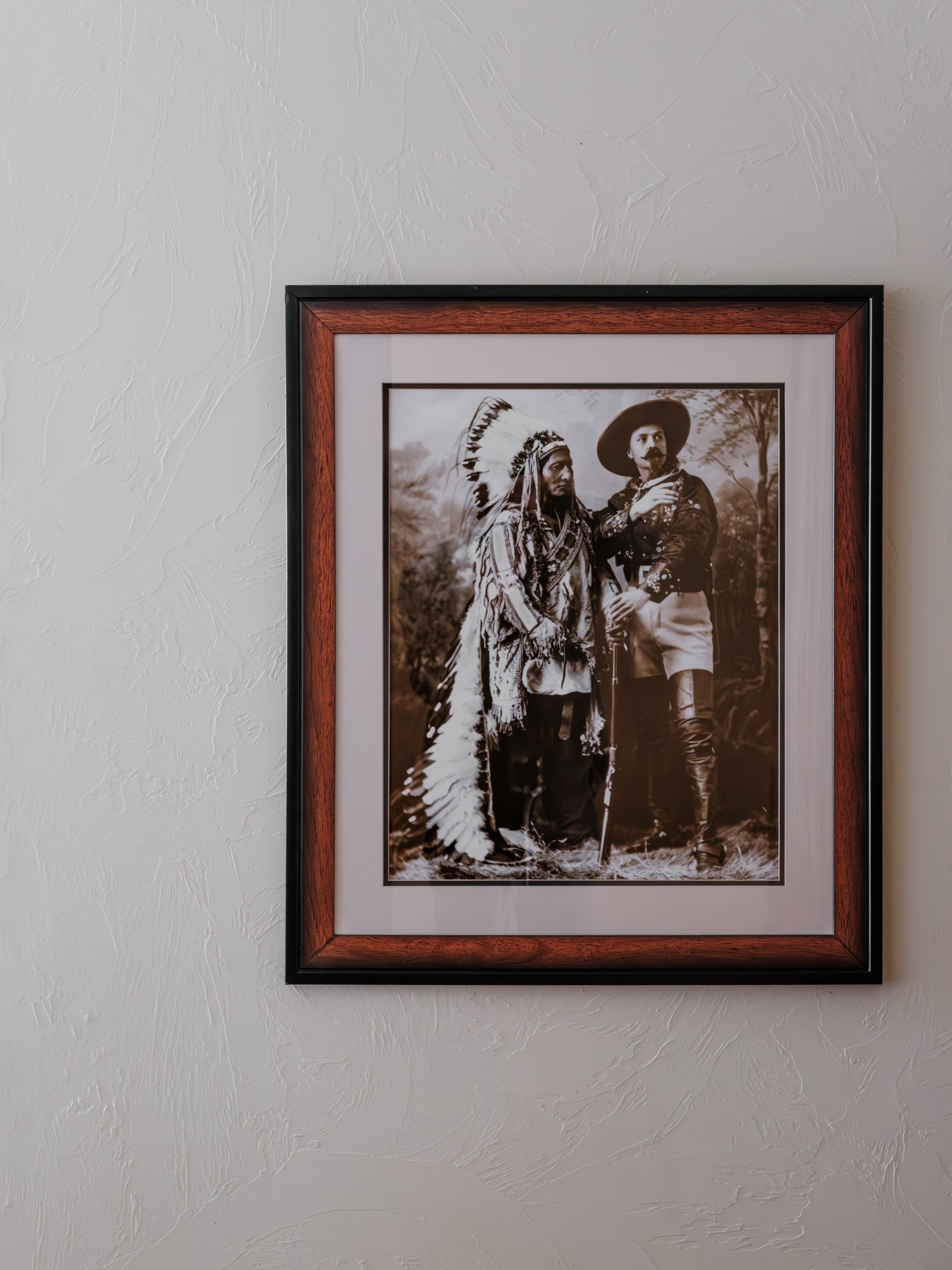 Western-inspired framed artwork in Big Sky lodge-style resort bedroom