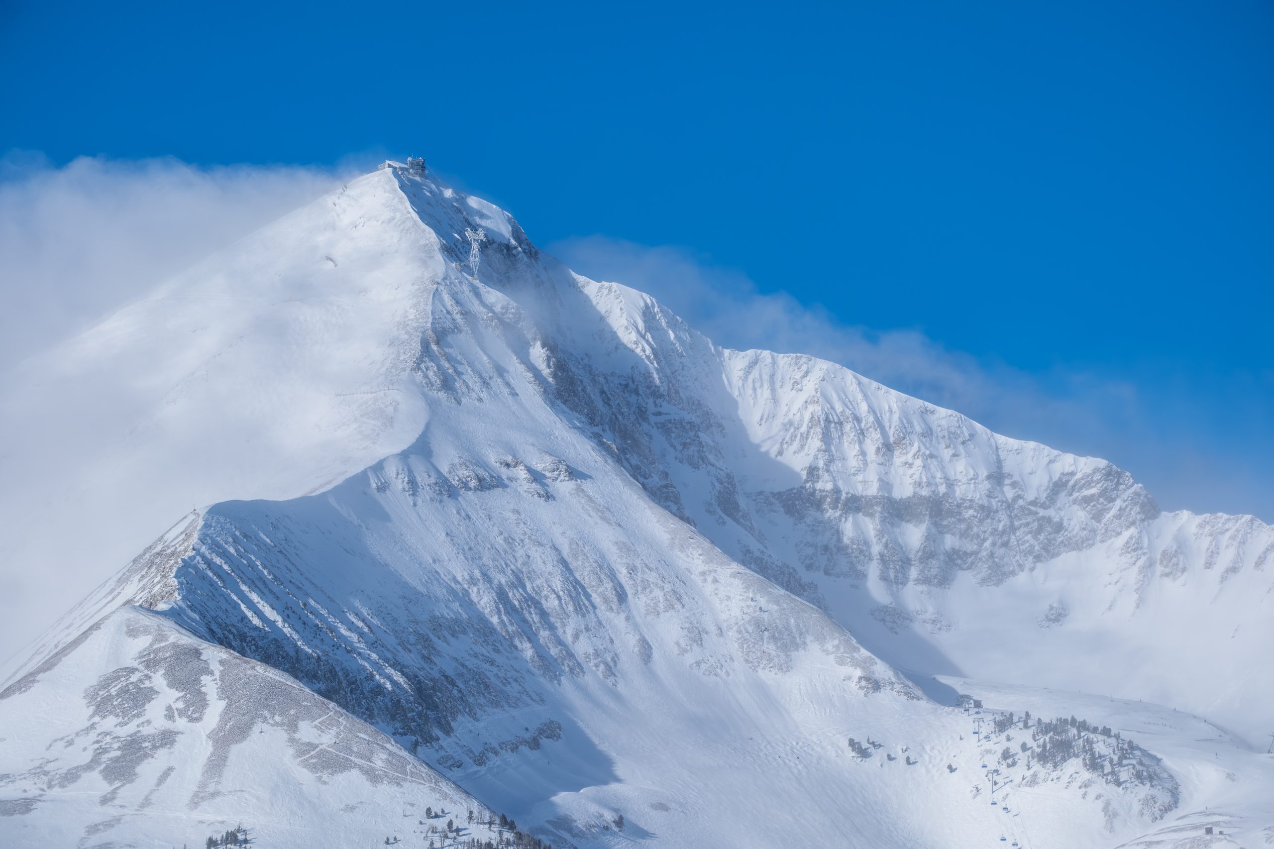 Close-up view of Lone Peak at Big Sky ski resort showcasing steep alpine terrain and fresh snow