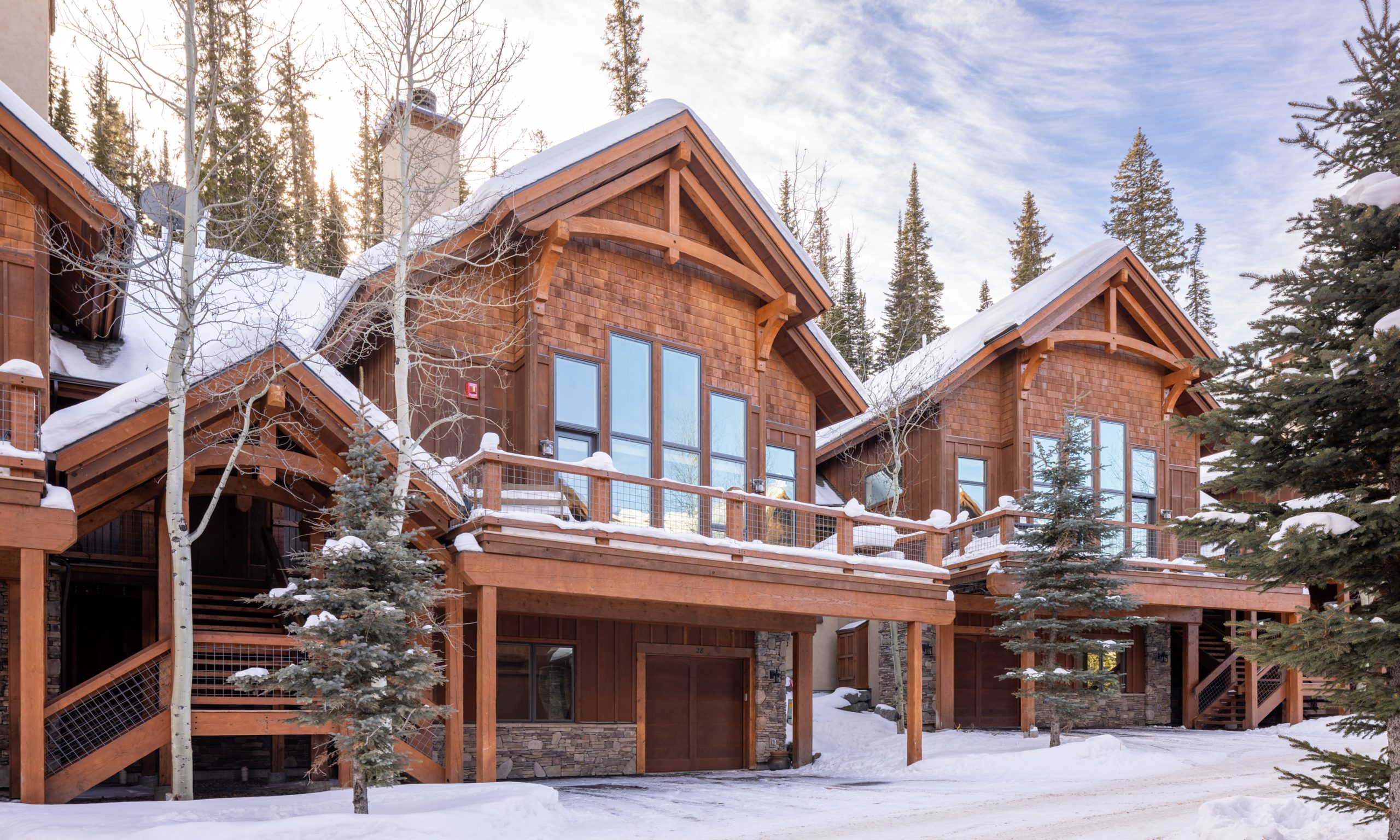 Luxury mountain home at Big Sky Resort covered in snow with direct ski-in:ski-out access