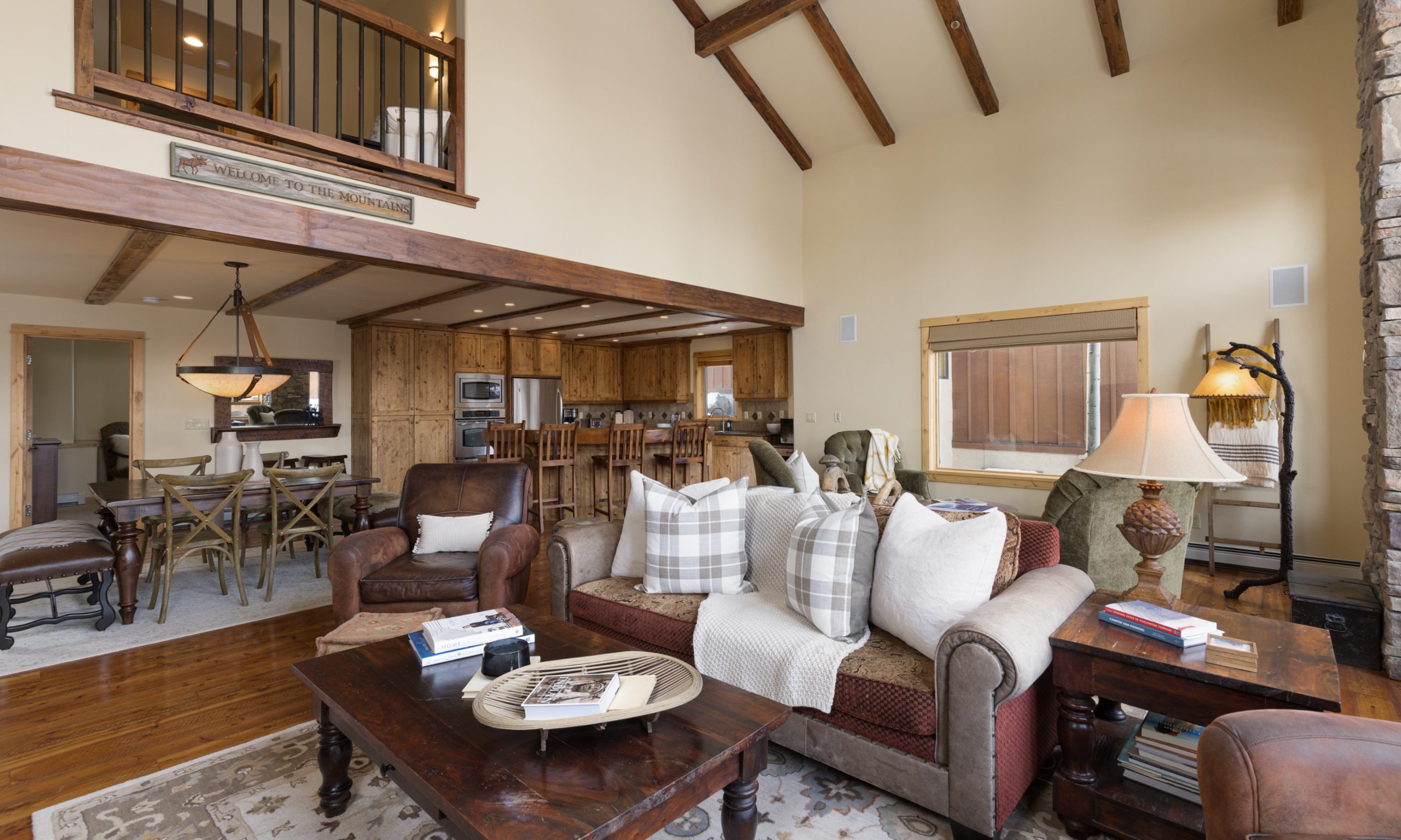 Luxury ski-in:ski-out lodge living room featuring rustic wood beams and cozy seating