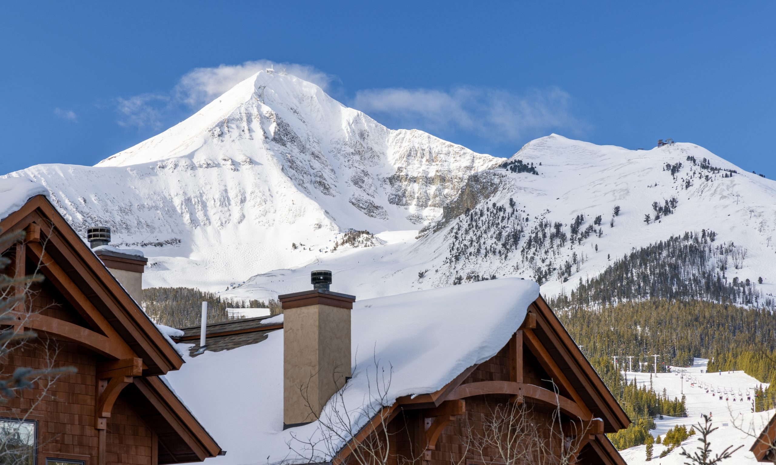 Snow-covered Big Sky Resort chalet with mountain views and direct access to skiing