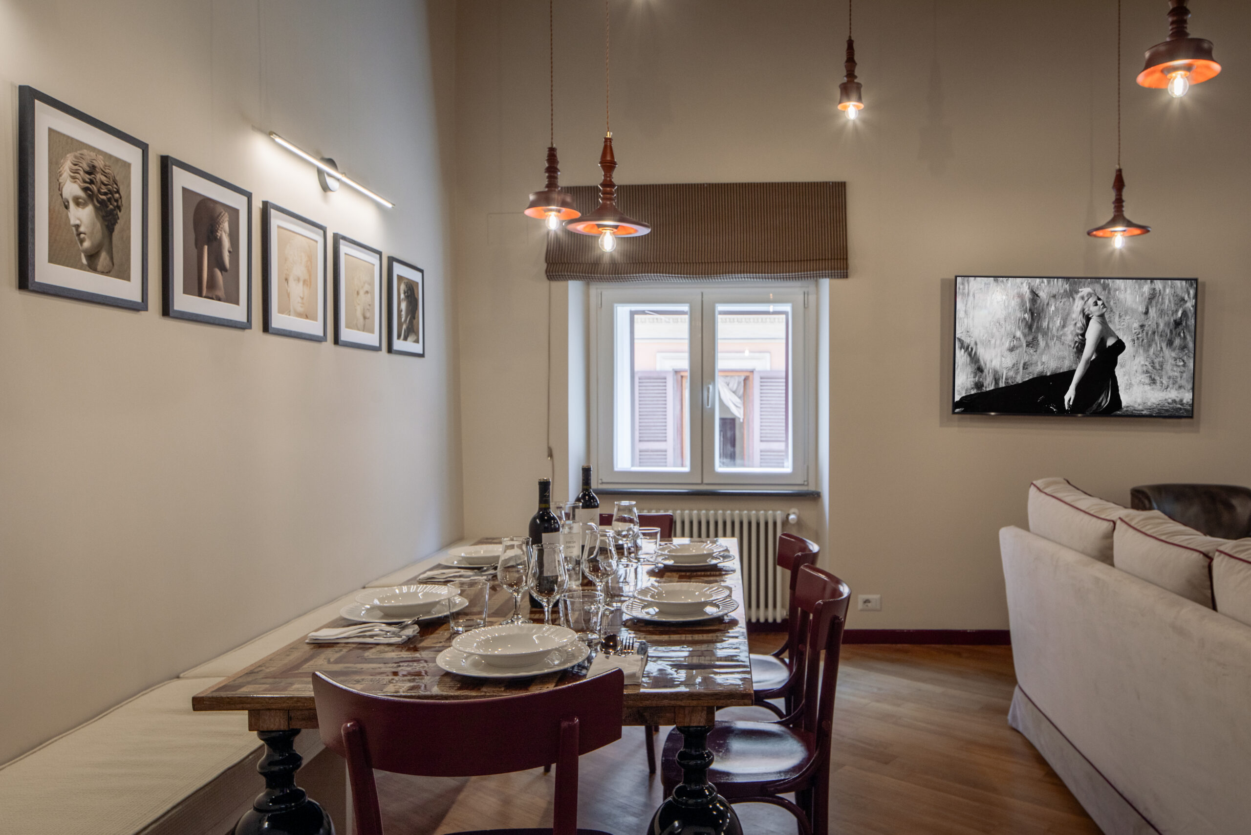 Elegant dining room with classic furnishings and rich red accents in a Rome apartment by Equity Residences_