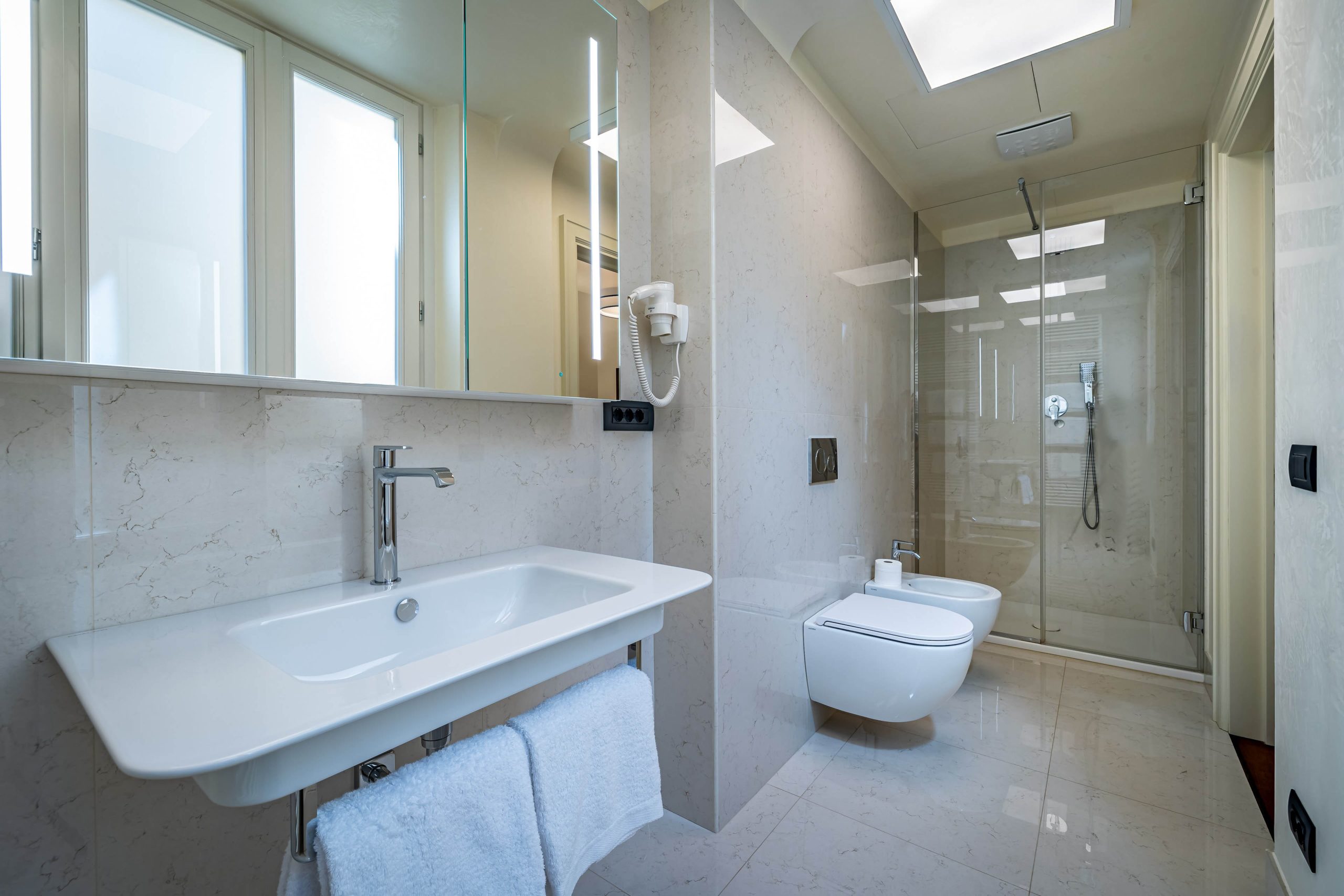Modern bathroom sink with towel rack in Florence luxury apartment with Duomo view