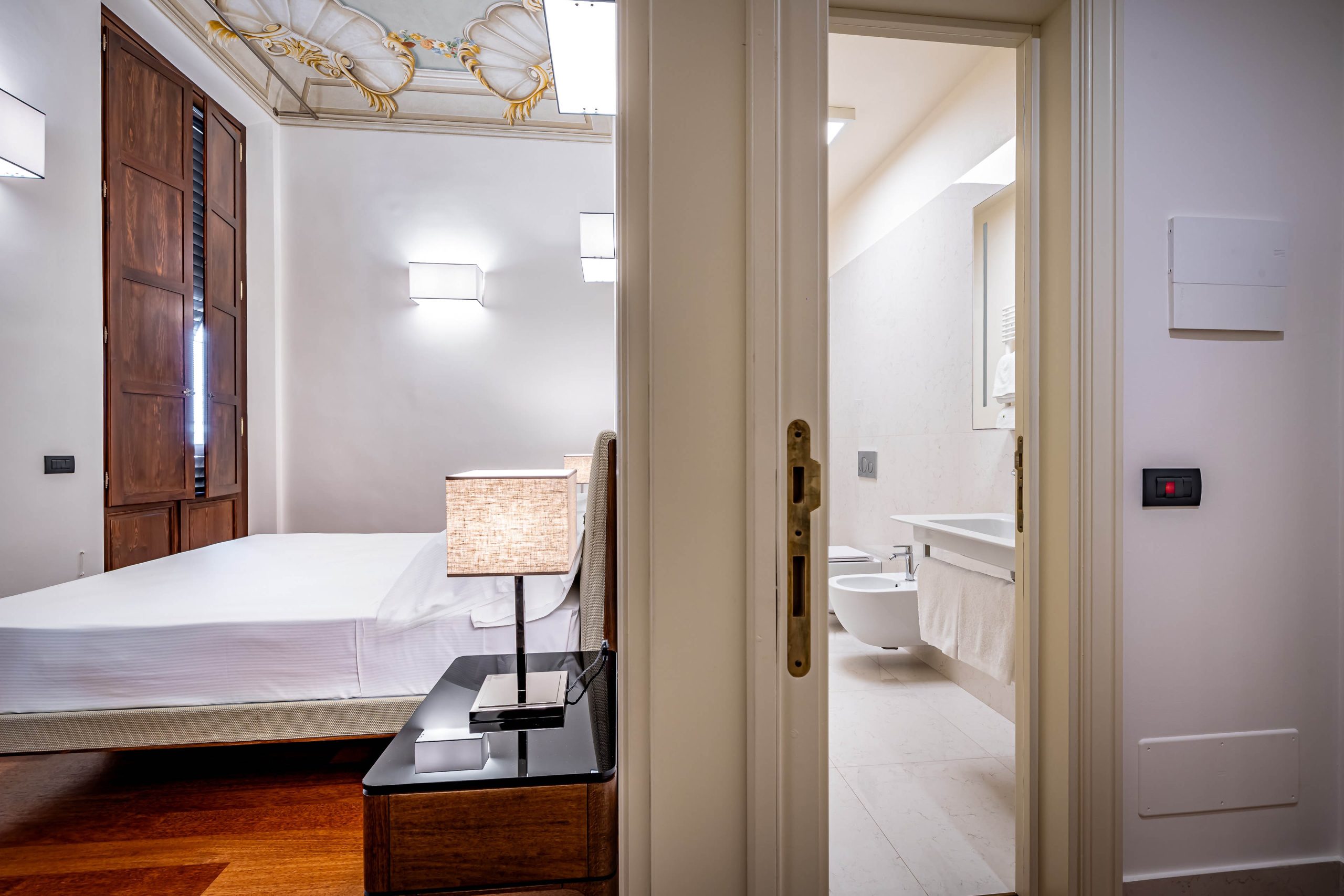 Bright modern bedroom with natural light in a luxury apartment in Florence with Duomo view