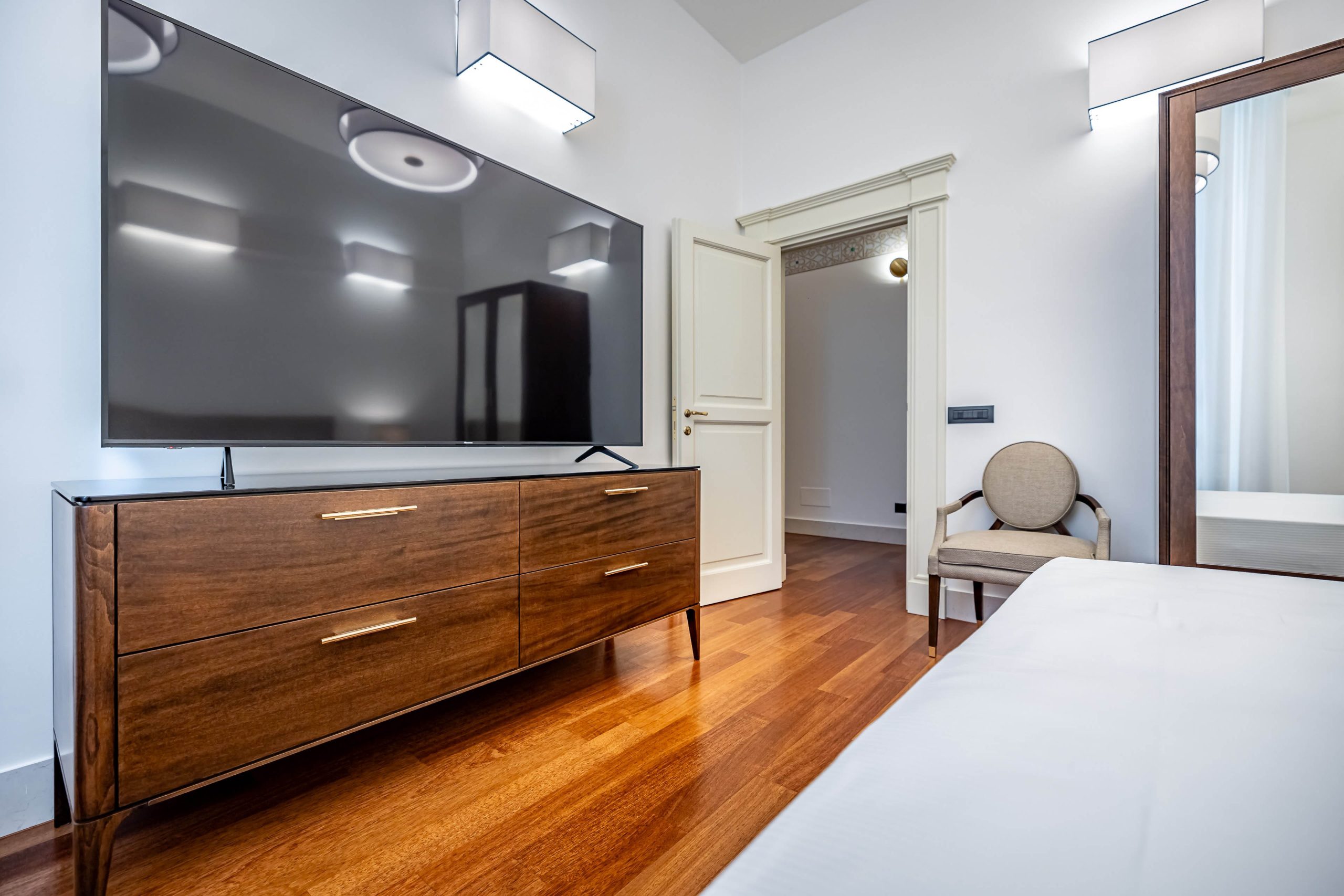 Bedroom with flat screen TV and elegant decor in a luxury apartment in Florence with Duomo view