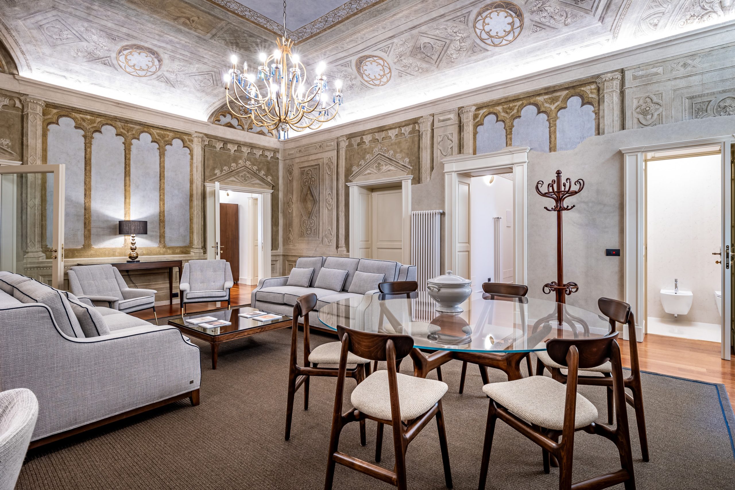 Fresco living room with chandelier in a luxury apartment in Florence with Duomo view