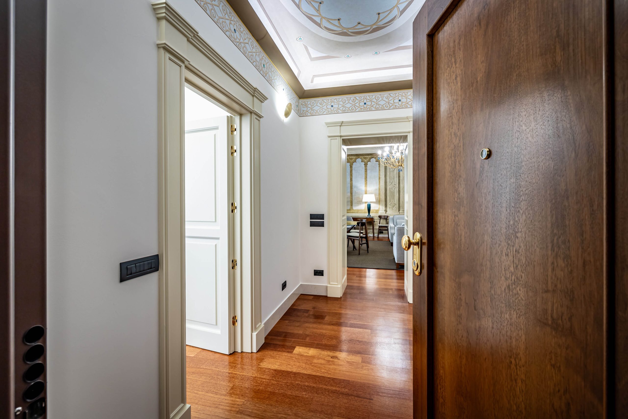 Stylish entrance hallway with wooden floors in a luxury apartment in Florence with Duomo view